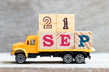 Truck hold letter block in word 21sep on wood background (Concept for date 21 month september)