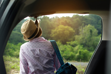 Asian girl traveling with a car on holiday.