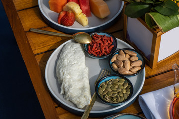 Healthy breakfast consisting of omelette, fruits, tea, variety of juice