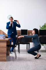Two employees doing sport exercises in the office