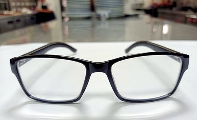 The front view of the glasses is clearly visible, placed on a white background.