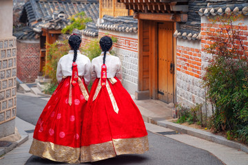 Korean lady in Hanbok or Korea dress and walk in an ancient town in seoul