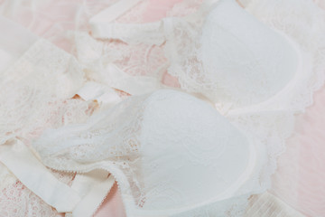 White women underwear with lace on pink background. whitebra and pantie.Copy space. Beauty, fashion blogger concept. Romantic lingerie for Valentine's day temptation. Erotic concept.