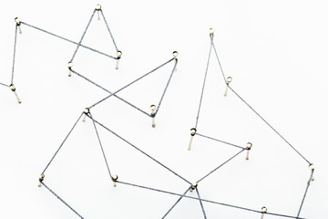A large grid of pins connected with string. Communication, technology, network concept