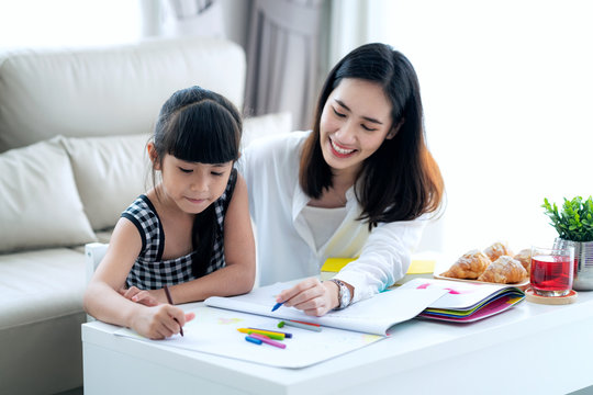 Mother teach Asian preschool student do homework