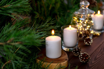 Obraz na płótnie Canvas Burning candles on the Christmas table.