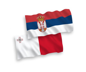 National vector fabric wave flags of Malta and Serbia isolated on white background. 1 to 2 proportion.