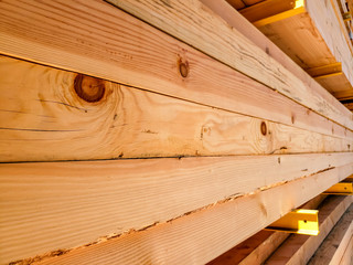 A closeup view of wooden beams at a lumber yard.