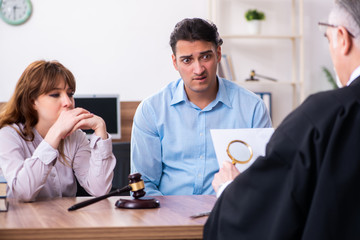 Young couple in the courthouse in divorce concept