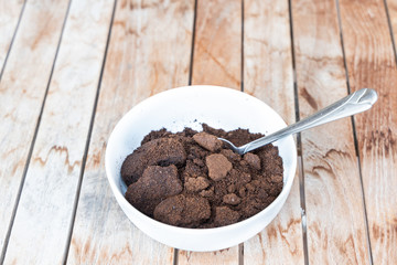 Spent coffee powder in bowl. Good as natural plant fertilizer.