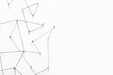 A large grid of pins connected with string. Communication, technology, network concept
