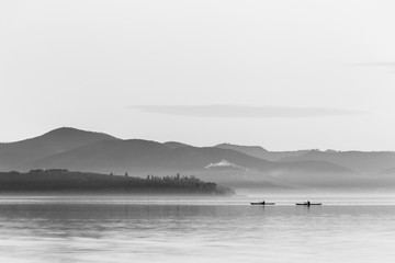 Beautiful view of a lake with two men on canoes