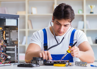 Computer repairman repairing desktop computer