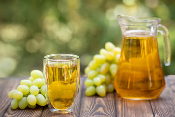 grape juice in glass and jug