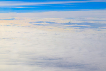 Beautiful white clouds in blue sky. View from airplane