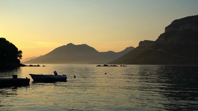Quiet summer evening on the Adriatic. The splash of waves, colorful sunset, nightfall