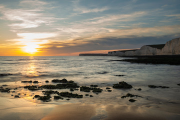 Beautiful vibrant Summer landscape sunset image of Seven Sisters chalk cliffs in England