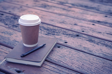 Brown paper cup of coffee photos in the park with copy space. Concept of beverage, brandingand logo, enjoy drink, refreshment or relaxation moment, happy time to get rest and leisure. Object mock up.