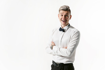 Portrait of young smiling handsome showman in white shirt with bowtie, studio shot isolated on white background. Businessman