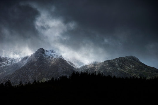 Stunning moody dramatic Winter landscape image of snowcapped Y Garn mountain in Snowdonia © veneratio