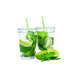 Two beautiful glasses with mojito and tubules. Isolated on white. Mint, rum, lime.