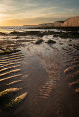 Beautiful vibrant Summer landscape sunset image of Seven Sisters chalk cliffs in England