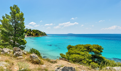 Rocky coastline and a beautiful clear water at Halkidiki peninsula in Greece - obrazy, fototapety, plakaty