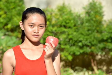 A Serious Female Youngster With Fruit