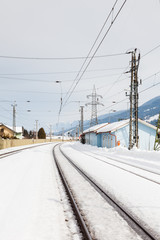The view along a snow covered railway track from Bruck - Fusch Station in the state of Salzburg, Austria.  Bruck and Fusch are both municipalities in Zell am See district.