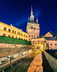 Naklejka premium Attractive evening view of famous medieval fortified city and the Clock Tower built by Saxons. Fantastic summer cityscape of Sighisoara, Transylvania, Romania, Europe. Traveling concept background.