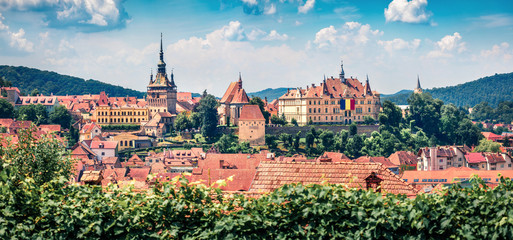 Obraz premium Panoramic morning cityscape of Sighisoara. Sunne summer view of medieval town of Transylvania, Romania, Europe. Traveling concept background.