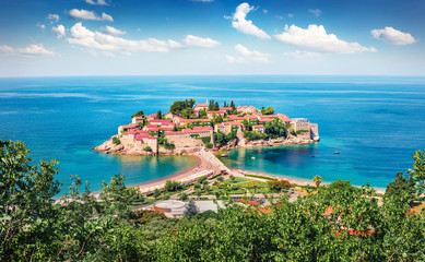 Aerial summer cityscape of Sveti Stefan town. Picturesque morning seascape of Adriatic sea, Montenegro, Europe. Beautiful world of Mediterranean countries. Traveling concept background.
