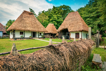 Fototapeta na wymiar Stunning summer view of traditional romanian peasant houses. Wonderful rural scene of Transylvania, Romania, Europe. Beauty of countryside concept background.