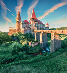 Picturesque morning view of Hunyad Castle / Corvin's Castle. Unbelievable summer sunrise in...