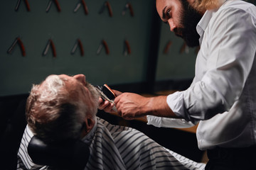 young barber working with brush and shaver . close up cropped photo.