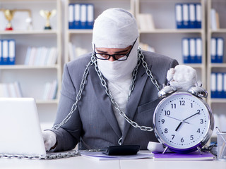 Bandaged businessman worker working in the office doing paperwor