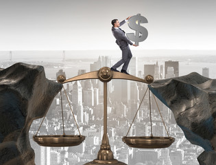 Businessman holding dollar sign in justice concept