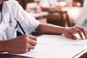 Students taking exam with stress in school classroom