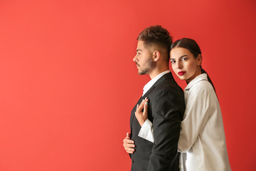 Stylish young couple on color background