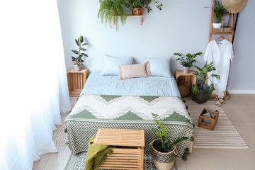 Interior of modern bedroom with houseplants