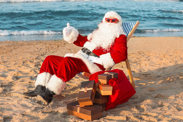 Happy Santa Claus with gifts at sea resort