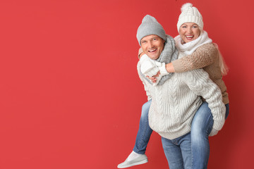 Fototapeta premium Portrait of happy mature couple having fun on color background