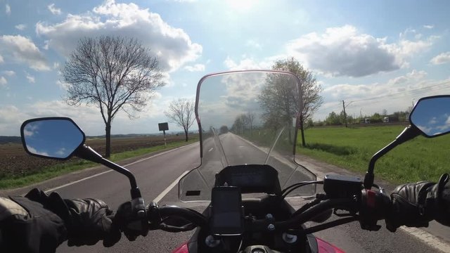 Motorcyclist riding on the Highway. View from behind the wheel of a motorcycle. POV