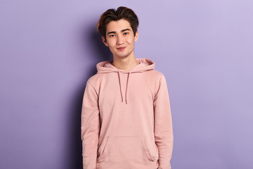 young cheerful handsome man in stylish sweatshirt looking at the camera, fashion , adult, style,...
