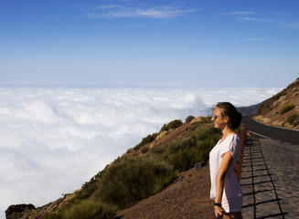 young woman on top of the mountain above the clouds - 291247668