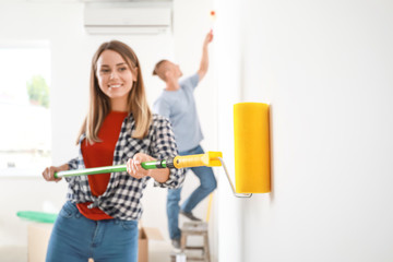 Happy young couple doing repair in their new house