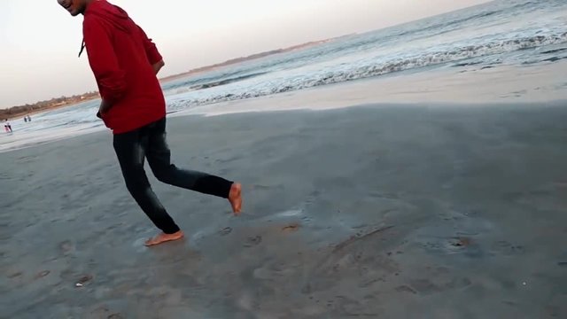 Man running on the Nagoa beach in Diu, India