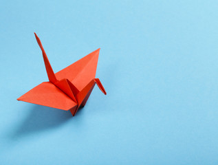 origami paper crane on a blue background