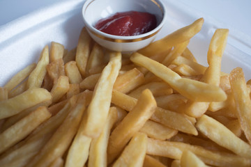 top view of french fries with ketchup on plate on the white table