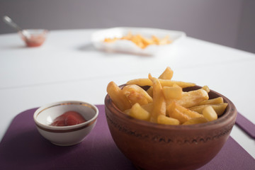 top view of french fries with ketchup on plate